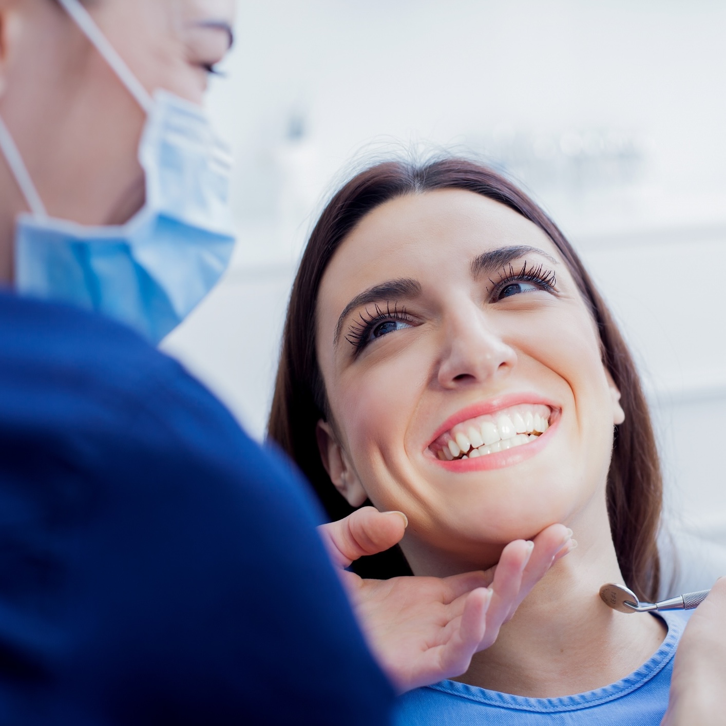 dentist checking lady's teeth
