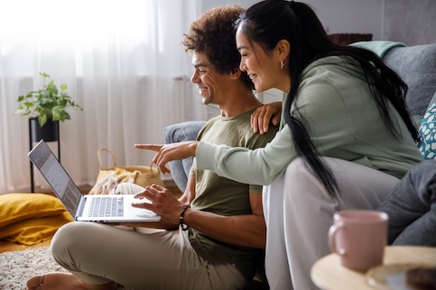 man and woman looking at a laptop