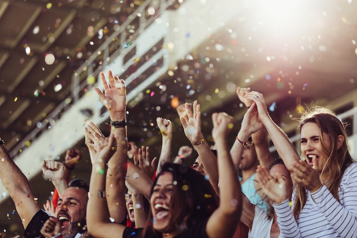 people cheering at a stadium