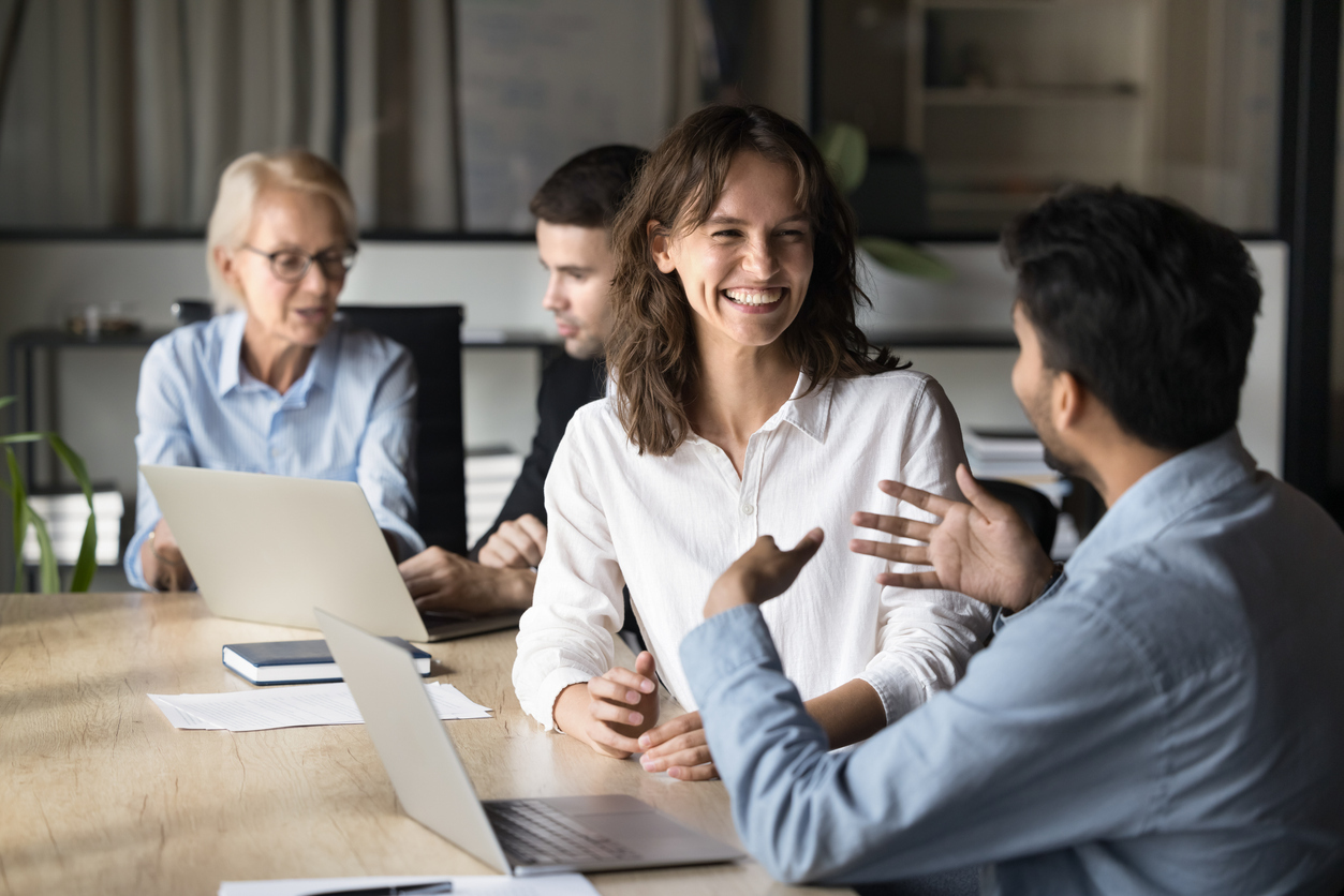 California small business employer and employee reviewing health insurance plan options together on a laptop, illustrating how benefit choice builds workplace trust