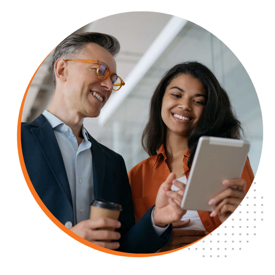 Smiling professionals looking at tablet